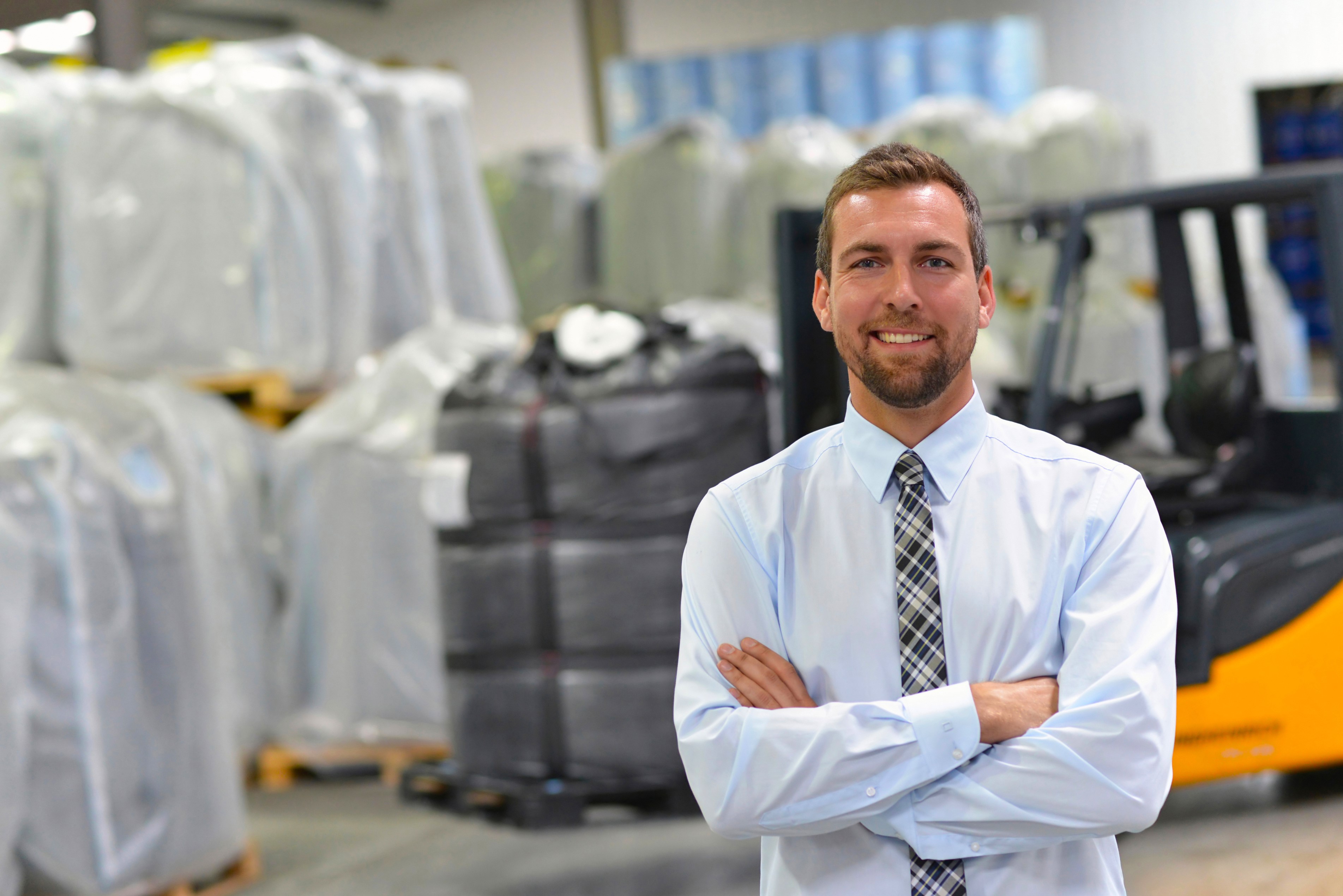 A businessman in a warehouse